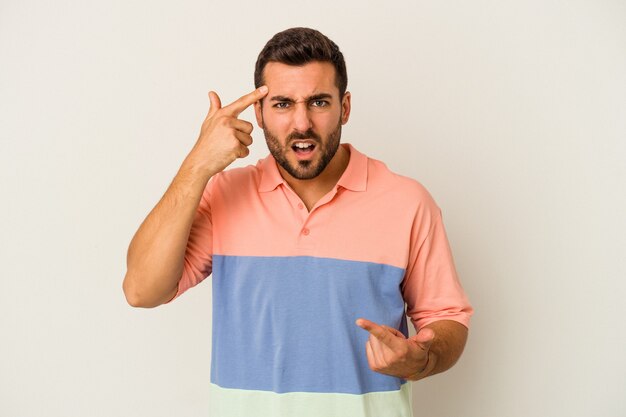 Young caucasian man isolated on white background showing a disappointment gesture with forefinger.