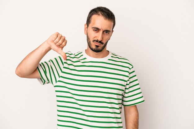 Young caucasian man isolated on white background showing thumb down, disappointment concept.