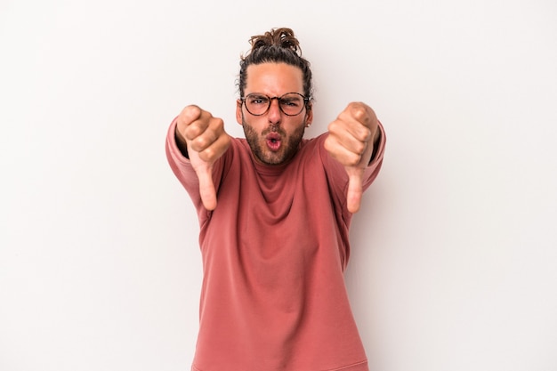 Young caucasian man isolated on white background showing thumb down and expressing dislike.