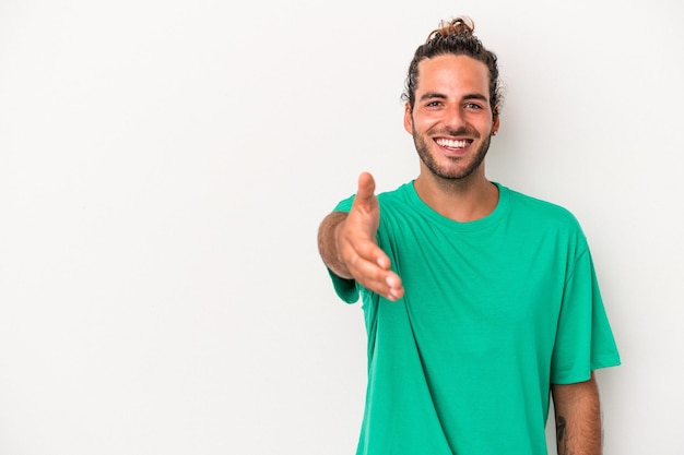 Young caucasian man isolated on white background smiling and raising thumb up