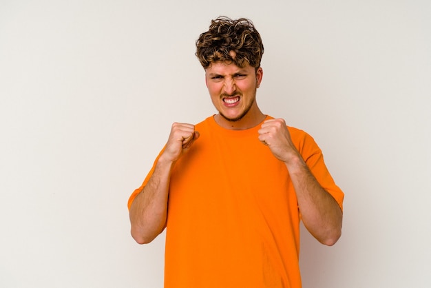 Young caucasian man isolated on white background upset screaming with tense hands.