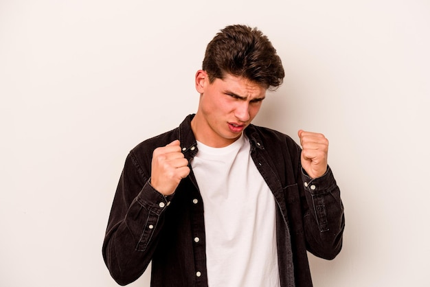 Young caucasian man isolated on white background upset screaming with tense hands