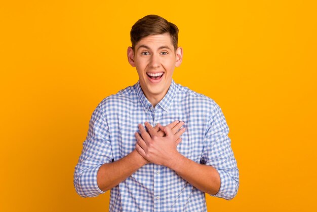 Young caucasian man isolated on yellow background relaxed and happy laughing showing teeth