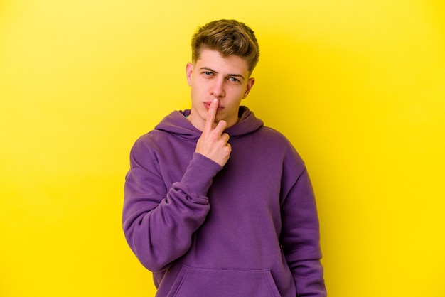 Young caucasian man isolated on yellow wall thinking and looking up, being reflective, contemplating, having a fantasy.