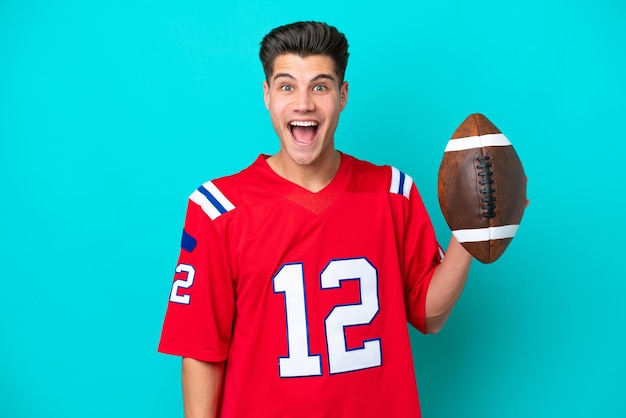 Young Caucasian man Playing rugby isolated on blue background with surprise facial expression