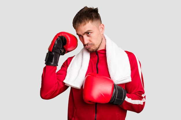 Young caucasian man practicing boxing cut out isolated