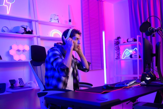 Young Caucasian man Pro Gamer have live streaming and chatting with his fans at home