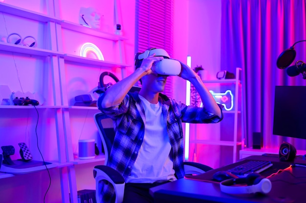 Young Caucasian man Pro Gamer have live streaming playing video game using virtual reality glasses