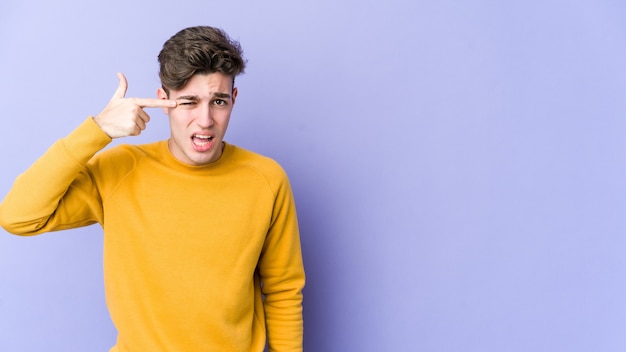 Young caucasian man showing a disappointment gesture with forefinger.