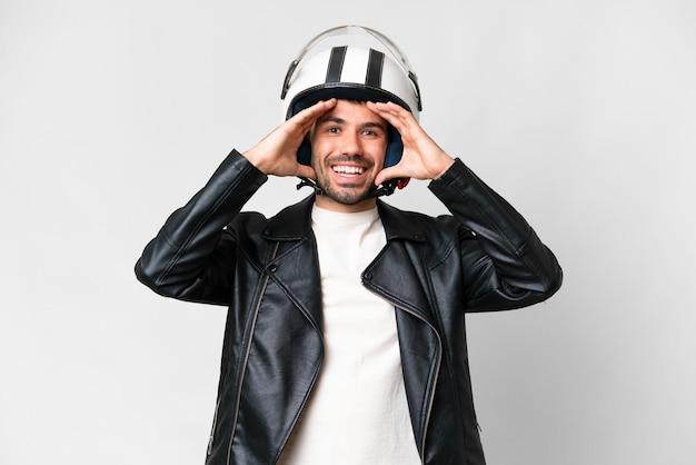 Young caucasian man with a motorcycle helmet over isolated white background with surprise expression