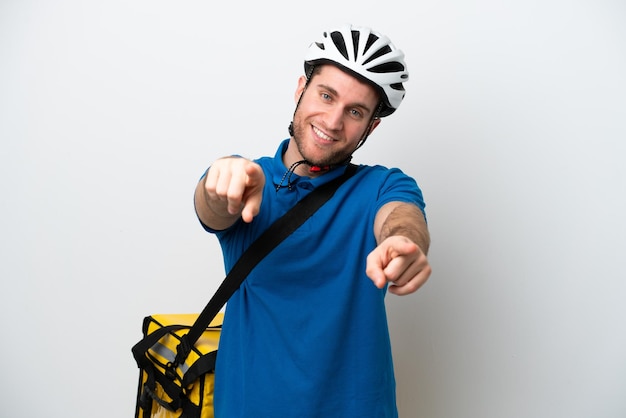 Young caucasian man with thermal backpack isolated on white background points finger at you while smiling