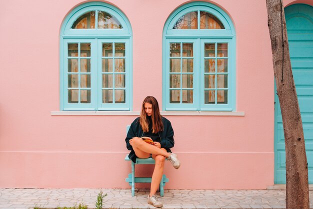 Young caucasian northern european woman sitting while reading a book