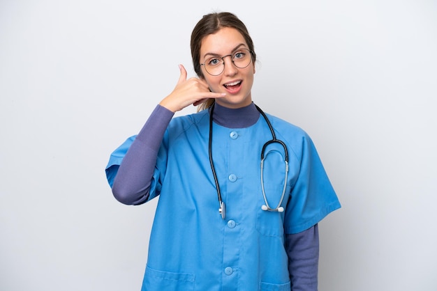 Young caucasian nurse woman isolated on white background making phone gesture Call me back sign