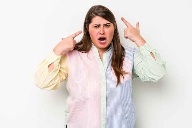 Young caucasian overweight woman isolated on white background showing a disappointment gesture with forefinger.