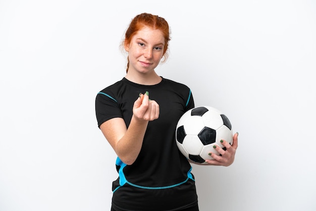 Young caucasian reddish football player woman isolated on white background making money gesture