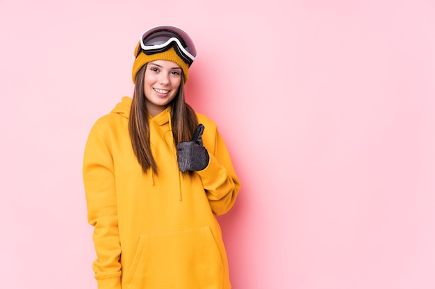 Young caucasian skier woman isolated smiling and raising thumb up