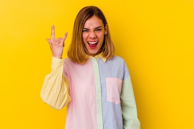 Young caucasian skinny woman  showing rock gesture with fingers