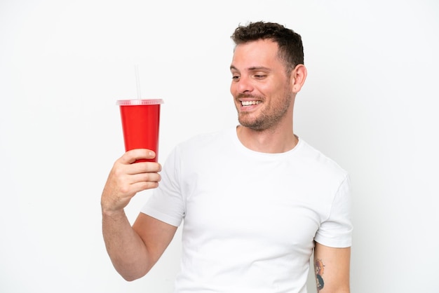 Young caucasian soda holding soda isolated on white background with happy expression