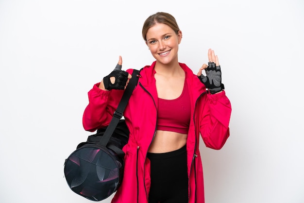 Young caucasian sport woman isolated on white background showing ok sign and thumb up gesture