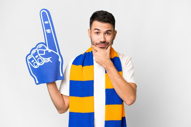 Young caucasian sports fan man over isolated white background thinking