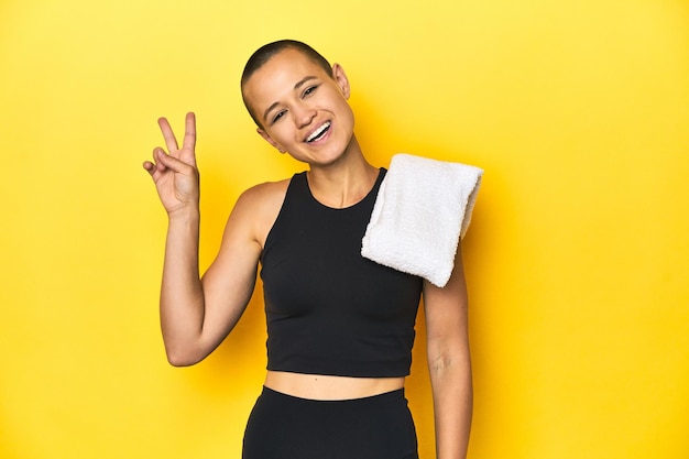 Young caucasian sporty woman on yellow background