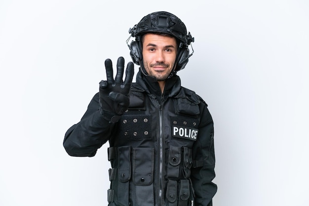 Young caucasian SWAT man isolated on white background happy and counting three with fingers