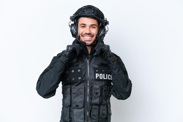 Young caucasian SWAT man isolated on white background smiling with a happy and pleasant expression