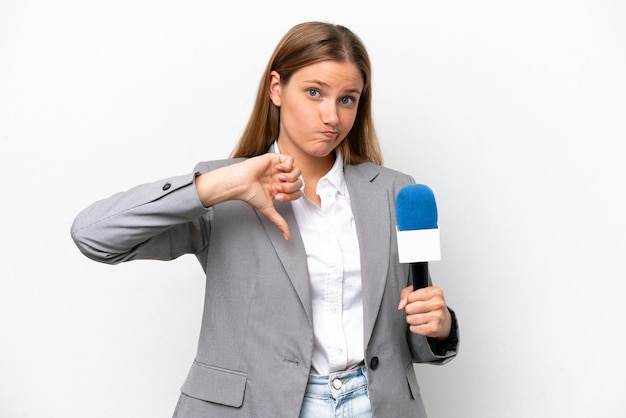 Young caucasian tv presenter woman isolated on white background showing thumb down with negative expression