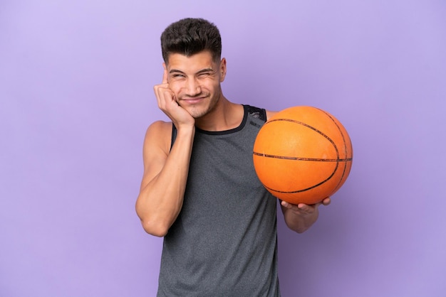 Young caucasian woman basketball player man isolated on purple background frustrated and covering ears