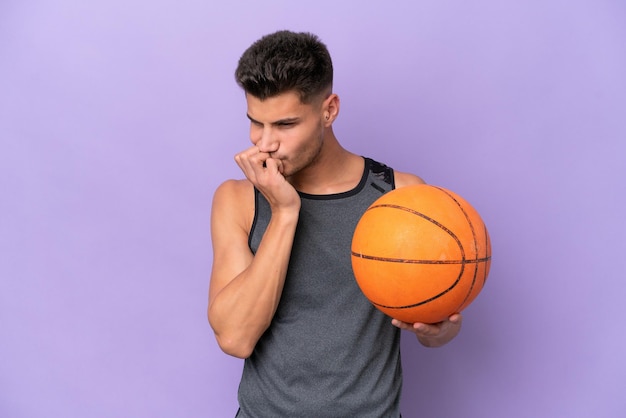 Young caucasian woman basketball player man isolated on purple background having doubts