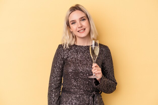 Young caucasian woman celebrating new year isolated on yellow background happy, smiling and cheerful.