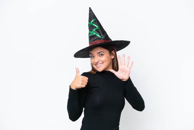 Young caucasian woman costume as witch isolated on white background counting six with fingers