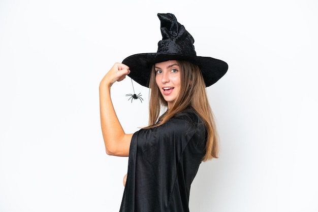 Young caucasian woman costume as witch isolated on white background doing strong gesture