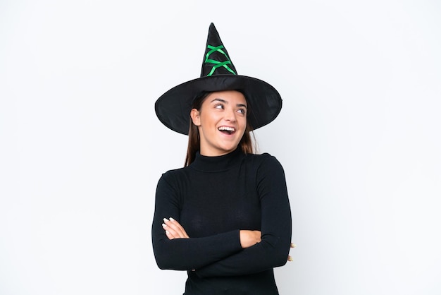 Young caucasian woman costume as witch isolated on white background happy and smiling