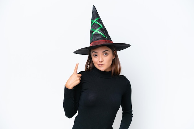 Young caucasian woman costume as witch isolated on white background pointing with the index finger a great idea