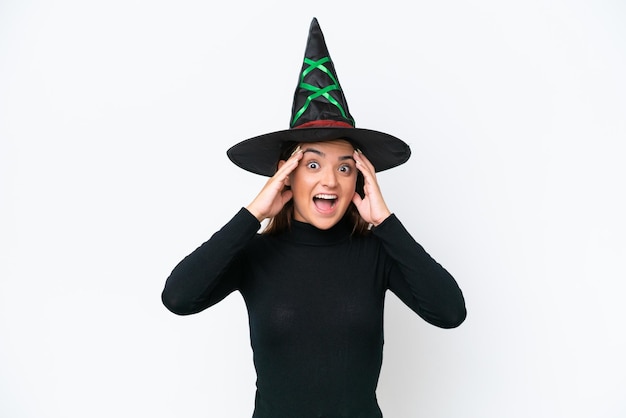 Young caucasian woman costume as witch isolated on white background with surprise expression