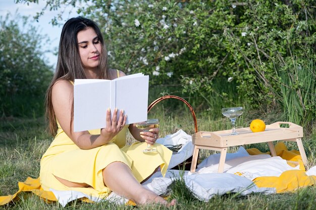 Young caucasian woman enjoying the flowering of an apple trees