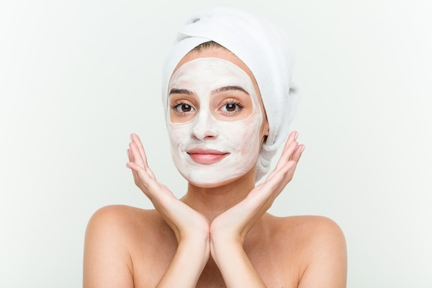 Young caucasian woman enjoying offacial mask treatment