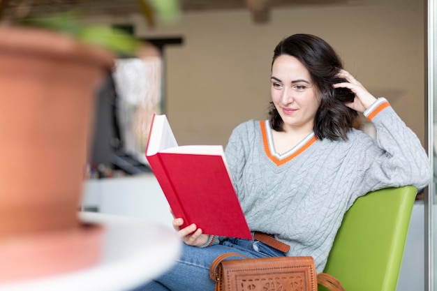 Young Caucasian woman enjoying reading a book Hobbies and pastimes Space for text