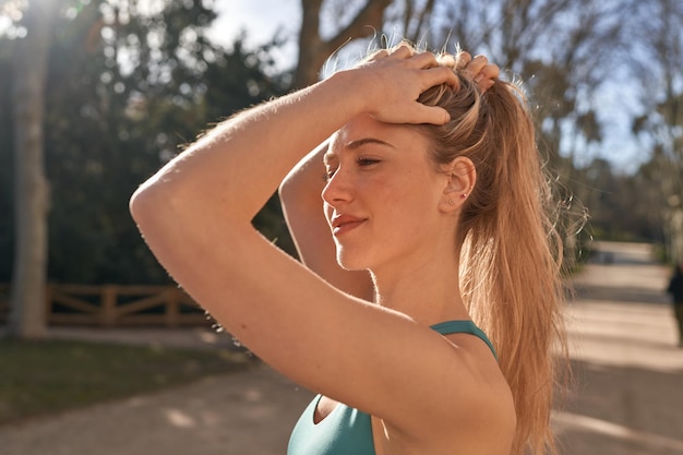 Young caucasian woman gets ready to conquer the outdoors with her running routine