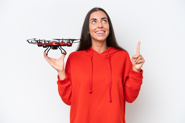 Young caucasian woman holding a drone isolated on white background