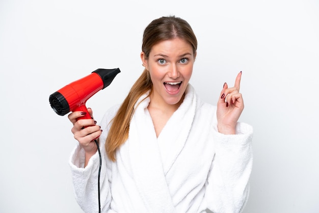 Young caucasian woman holding hairdryer isolated on white background pointing up a great idea