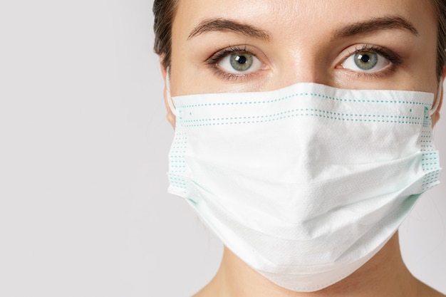 Young caucasian woman is wearing a face mask for protection against virus