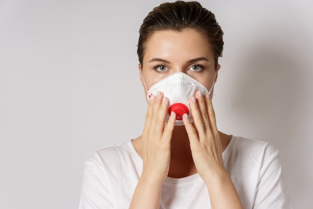 Young caucasian woman is wearing a face mask for protection against virus