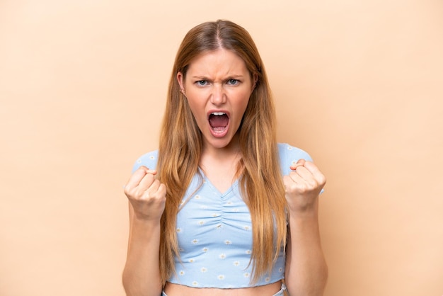 Young caucasian woman isolated on beige background frustrated by a bad situation