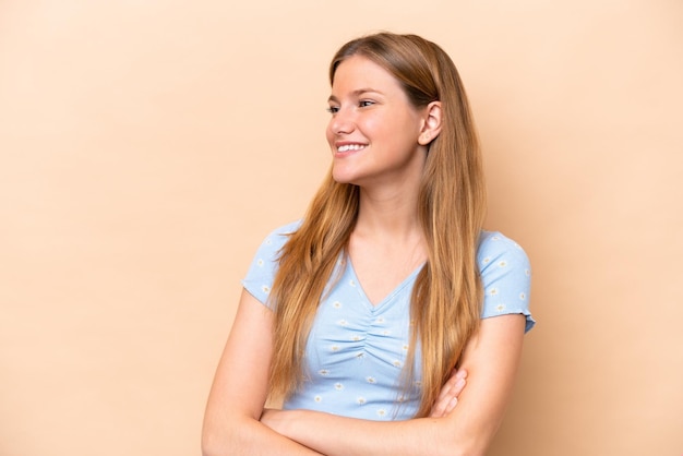 Young caucasian woman isolated on beige background happy and smiling