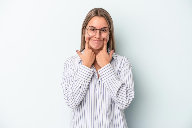 Young caucasian woman isolated on blue background doubting between two options.