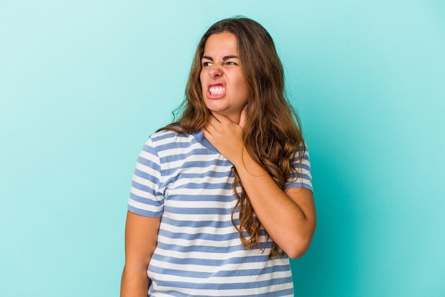 Young caucasian woman isolated on blue background  touching back of head, thinking and making a choice.