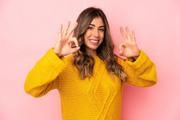 Young caucasian woman isolated cheerful and confident showing ok gesture