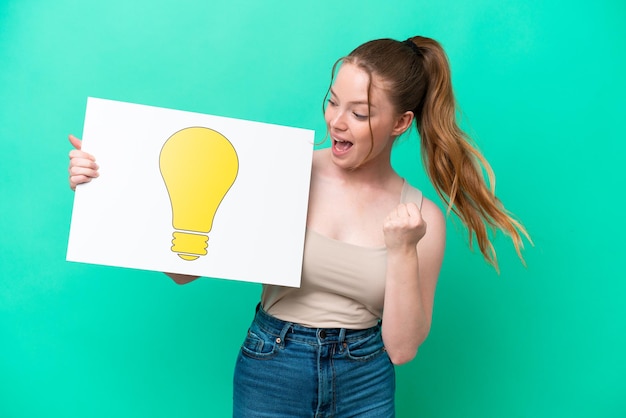 Young caucasian woman isolated on green background